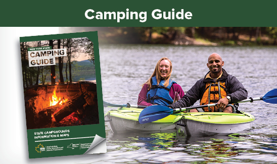 Camping Guide. Two people floating in water on bright green kayaks. The one person is wearing a blue lifejacket, while the other is wearing an orange lifejacket. To the left of the kayakers, is the New York State Camping Guide, superimposed over the image. The camping guide is green and the bottom right corner of the cover is folded as to indicate a turning page. On the cover of the camping guide there is an image of a campfire and the text, "New York State Camping Guide." There is additional text that reads, "State Campgrounds Information & Maps."