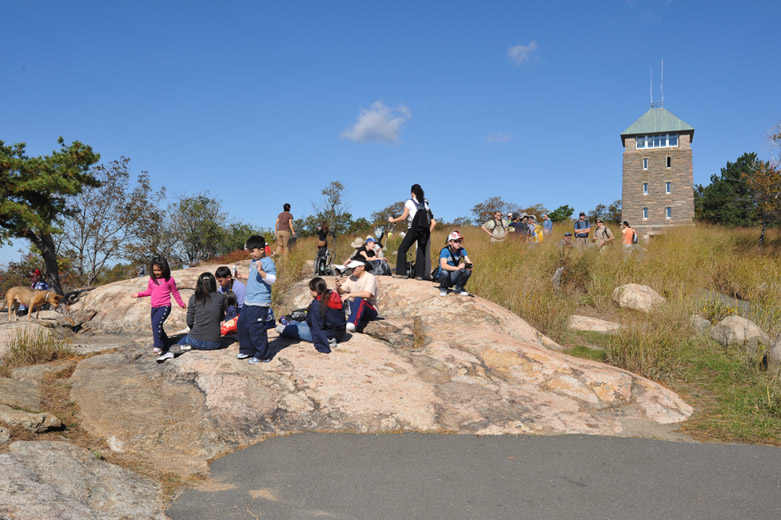 The Perkins Memorial Drive and Tower were built with funds provided by his descendants, to honor George Walbridge Perkins, first PIPC president and widely regarded as its founder.The sinuous and steep Drive, which leads to the Tower 1,305 feet above the Hudson River, was blasted off the mountain by 1,500 workers using 50,000 tons of dynamite. The tower, built to serve as a weather station and fire lookout, served those purposes until the 1950s. Work began in 1932, thanks to labor provided by the NYS Temporary Relief Administration. The drive and tower were inaugurated in 1934. With its 360-degree panorama, the Perkins Memorial Tower offers spectacular views of the Hudson River, the Bear Mountain Bridge, U.S. Military Academy at West Point, Storm King, and Fort Montgomery. Four states are visible (New York, New Jersey, Connecticut, and Pennsylvania), as well as the New York City skyline. The observation floor has interpretive displays that describe the distant views, which include several mountain ranges: the Taconics, Ramapos, Shawangunks, and even the Catskills. Perkins Memorial Drive and Tower truly are a highlight of any visit to Bear Mountain.